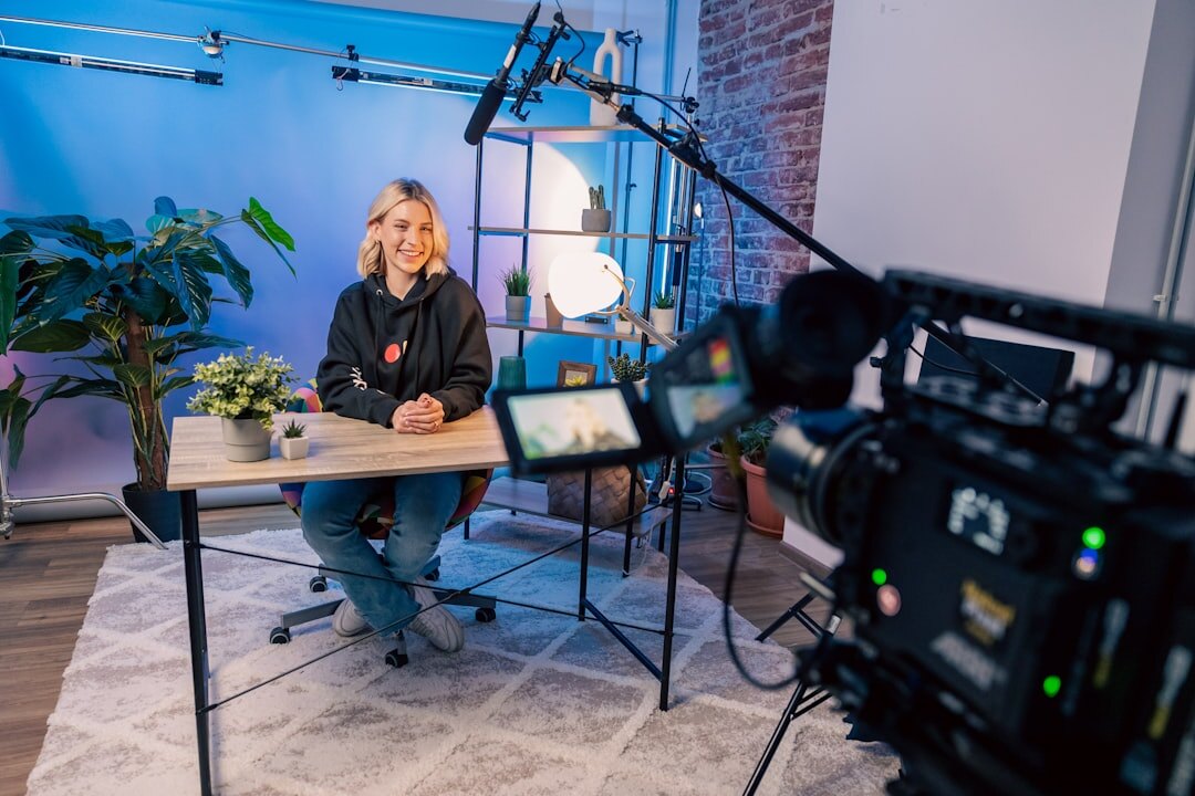News presenter reading from an autocue on a studio set