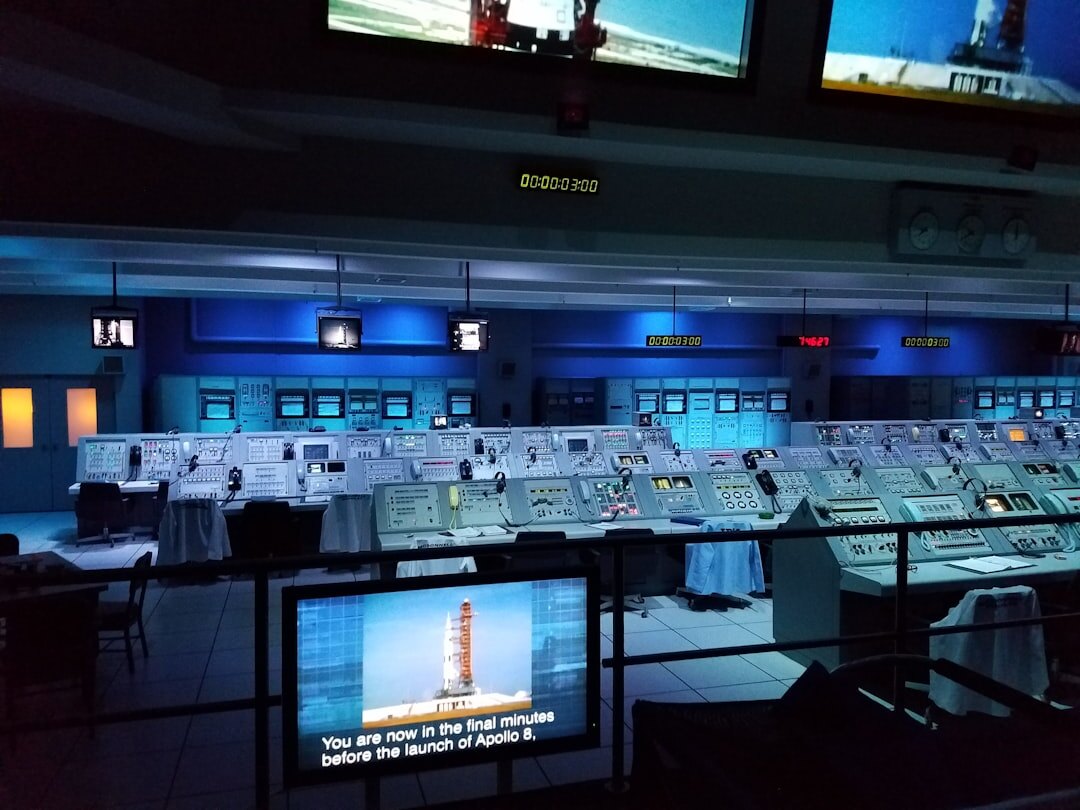 Broadcast control room with directors monitoring multiple screens